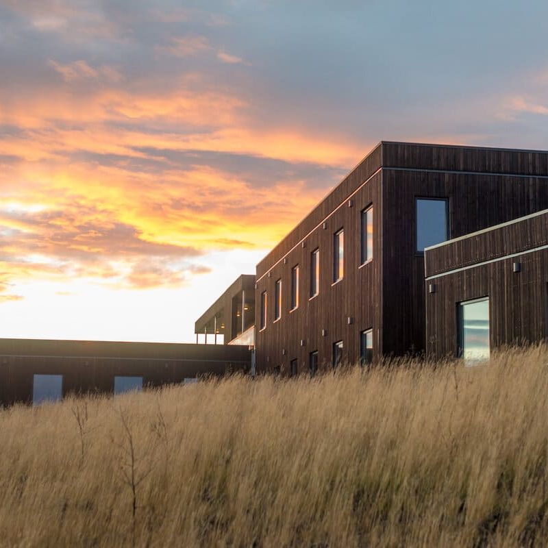 Hotel Laxa with a beautiful sky above, showcasing a picturesque setting in North Iceland.