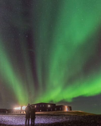 Guests viewing the Northern Lights in front of Hotel Laxa in Iceland